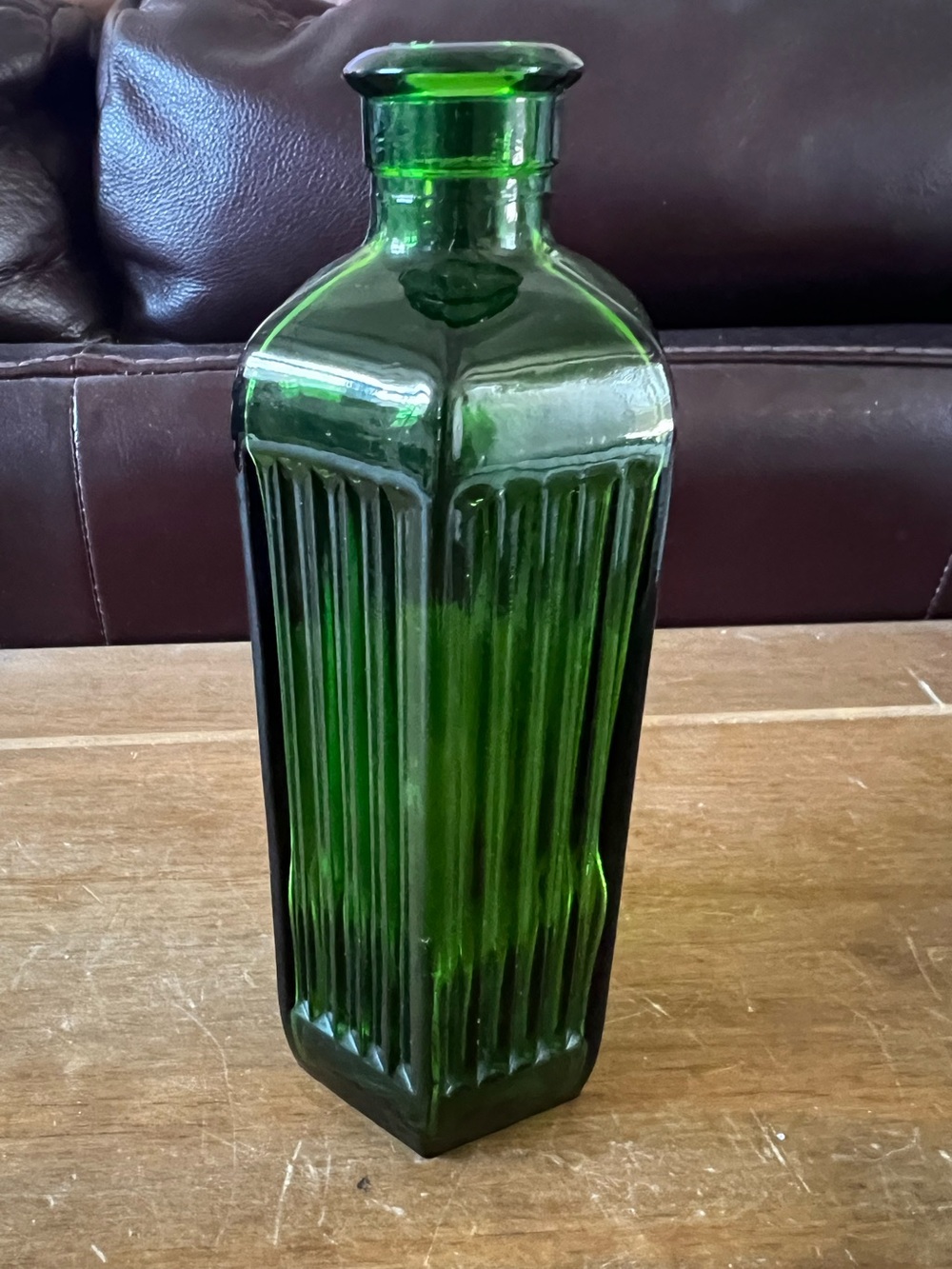 Vintage  six sided green glass bottle. Excellent condition. 6 1/2” tall